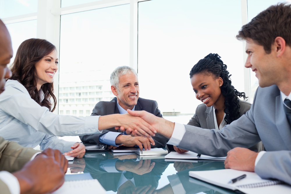 Handshake between a businesswoman and a co-worker when a meeting is ending Handshake between a businesswoman and a co-worker when a meeting is ending